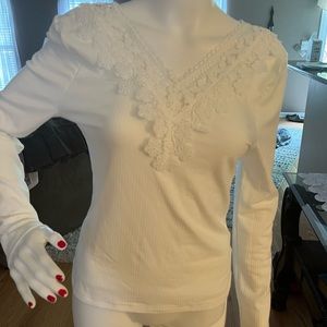 Beautiful white top v neck front and back. Poly blend.  New without tags